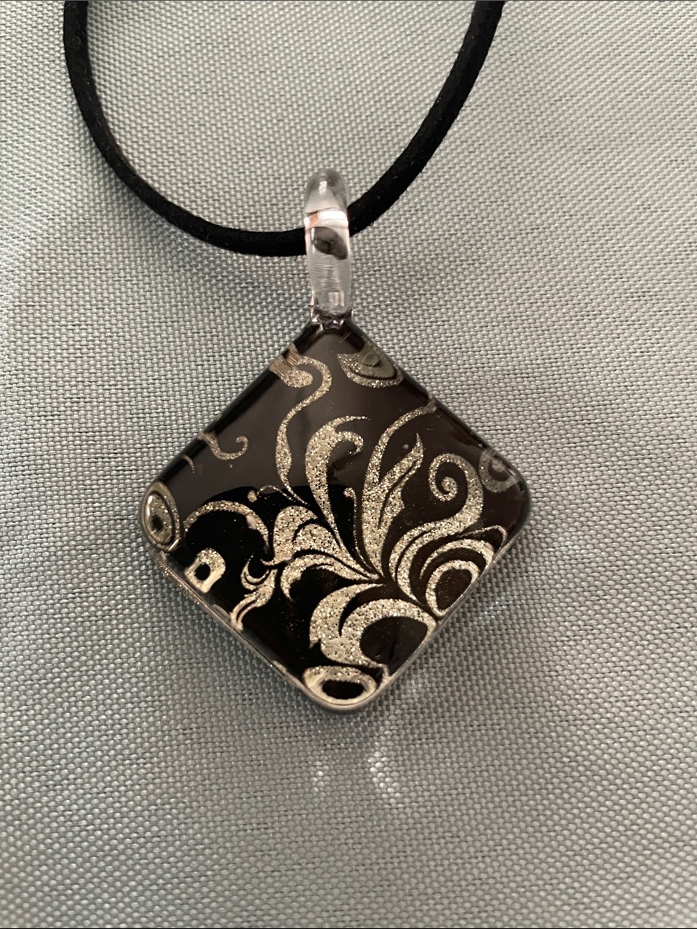 Chuvora Black Glass Pendant Necklace with Gold Swirl Motif